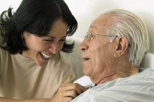 Smiling senior male with caregiver