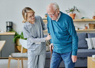 Caregiver helping senior around the house