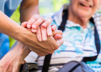 Caregiver helping senior get around outside