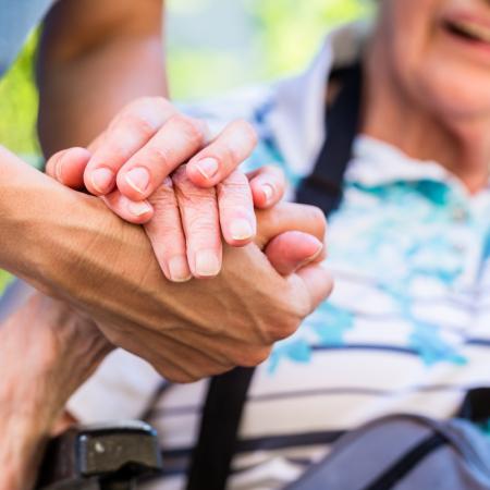 Caregiver helping senior get around outside