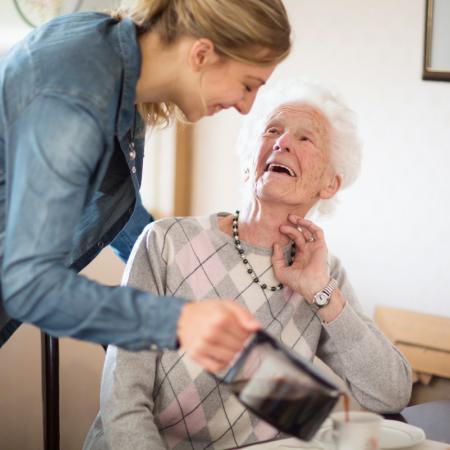 Senior being taken care of by their adult child